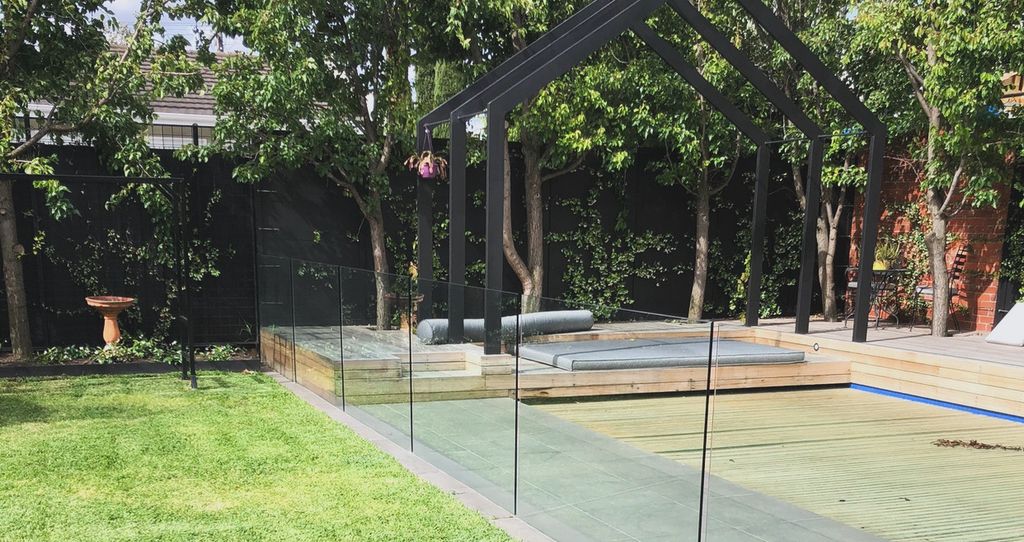Premium garden with manicured lawn, pool deck and steel pergola structure