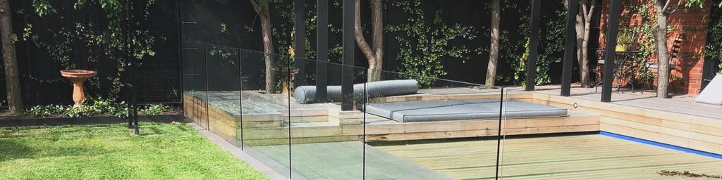 Modern garden with pristine lawn, pool deck and steel pergola